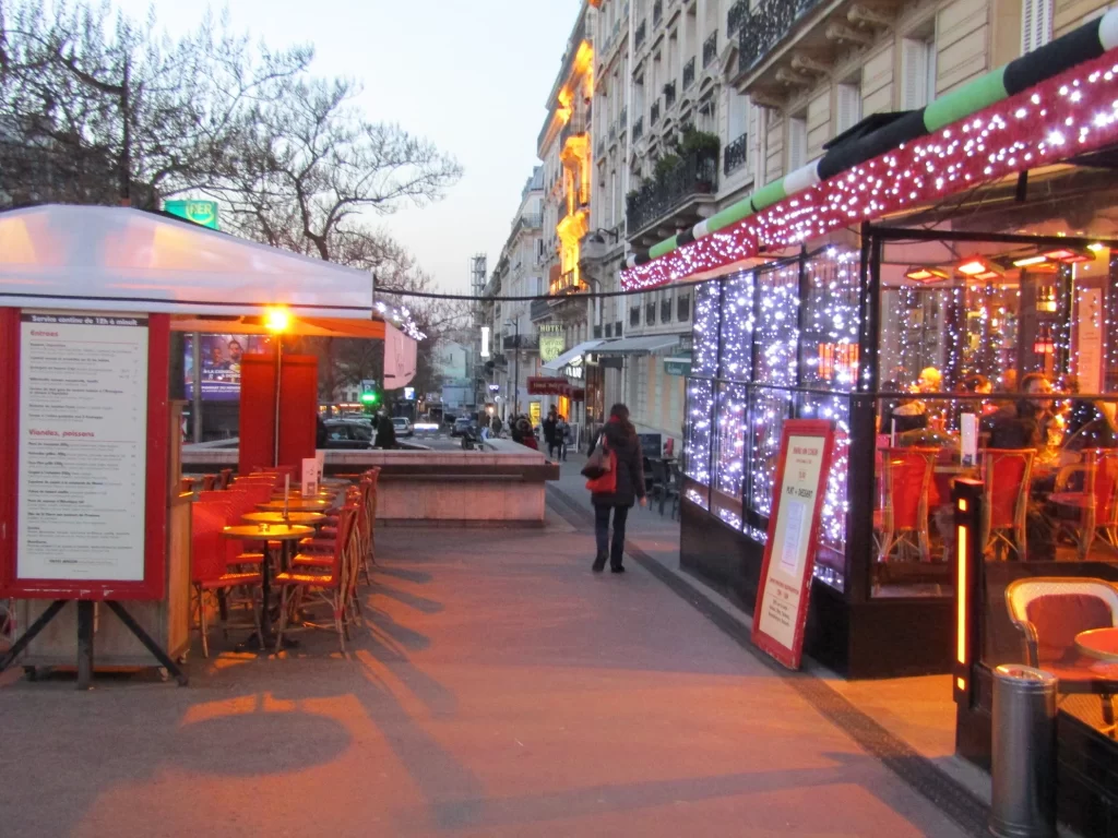 Parisian sidewalk with cafes and Christmas lights